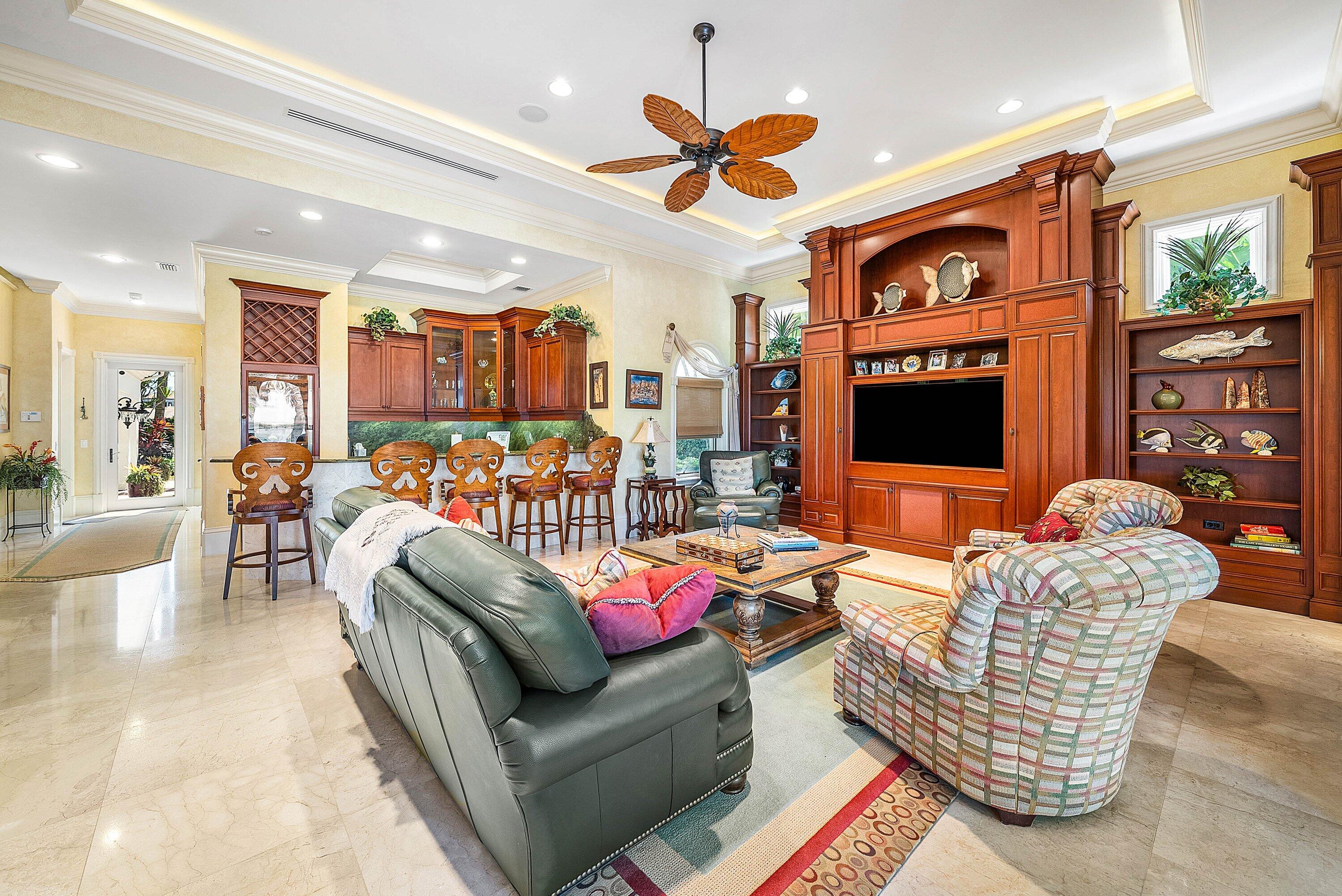 6381 Southeast Harbor Circle Stuart, FL 34996 - Photo 26 of 102 a living room with furniture kitchen view and a flat screen tv