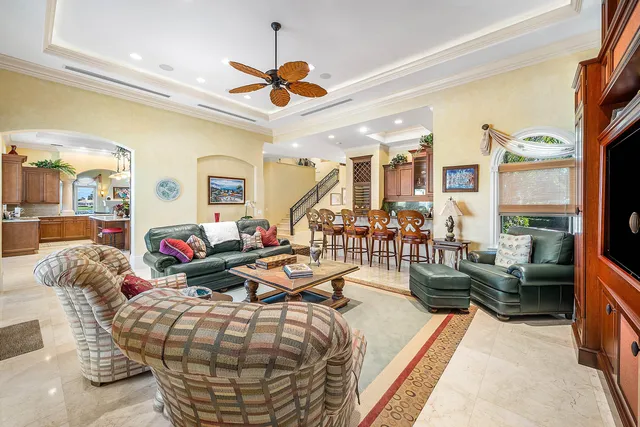 a living room with furniture chandelier and a window