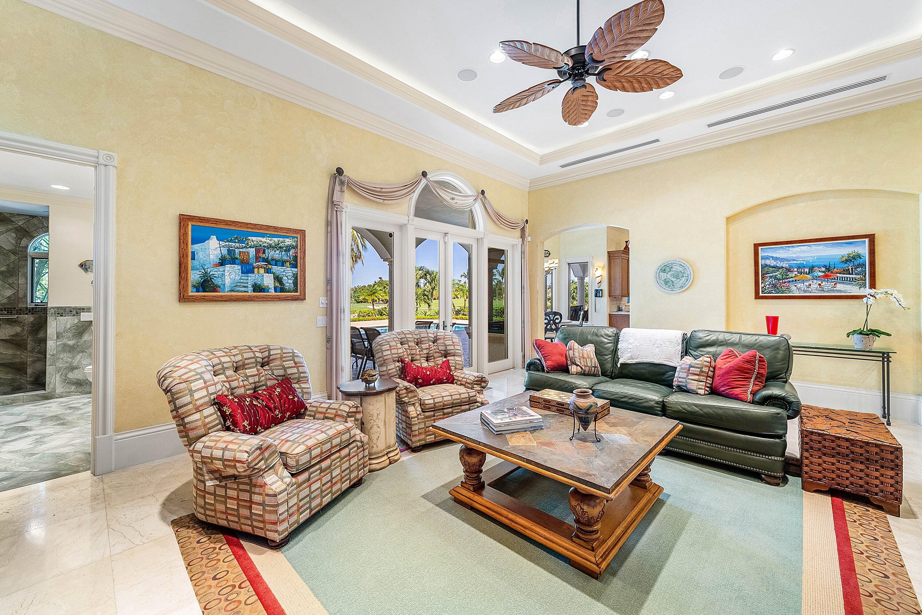 6381 Southeast Harbor Circle Stuart, FL 34996 - Photo 28 of 102 a living room with furniture a rug and a chandelier