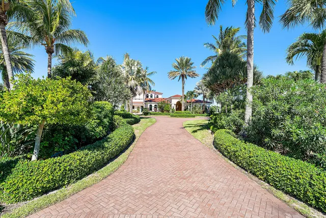 a front view of a house with a yard and a garage