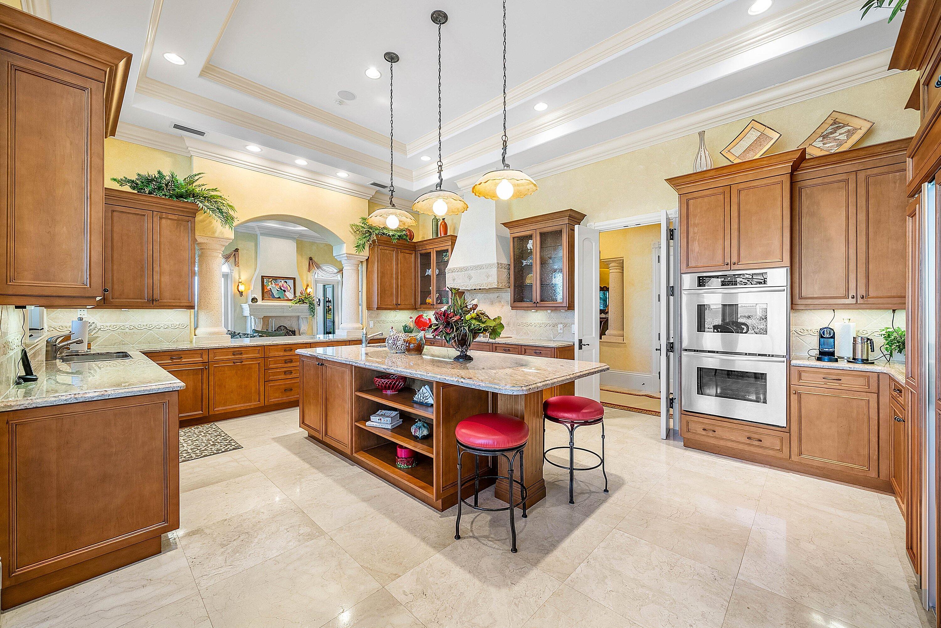 6381 Southeast Harbor Circle Stuart, FL 34996 - Photo 34 of 102 a kitchen with stainless steel appliances kitchen island granite countertop a stove a sink and a refrigerator