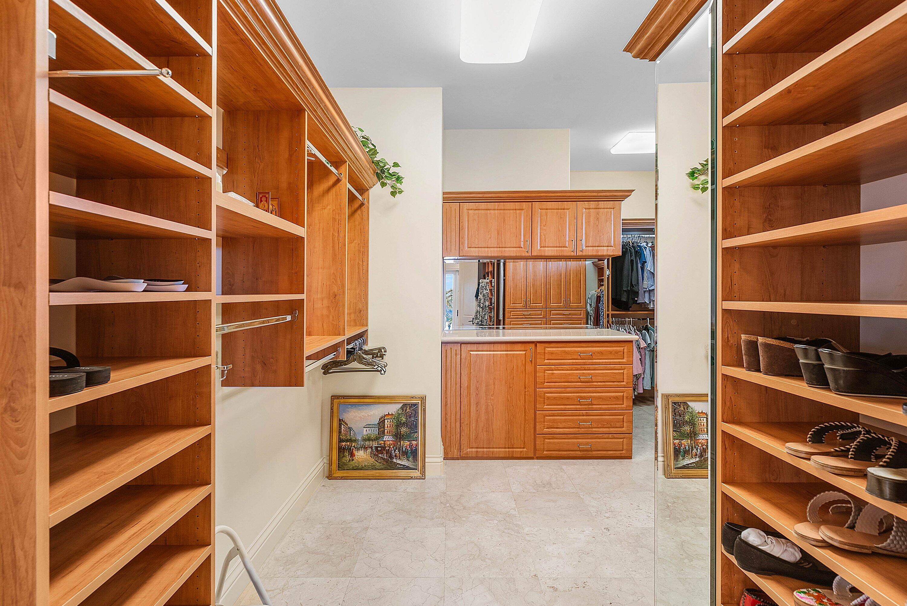 6381 Southeast Harbor Circle Stuart, FL 34996 - Photo 41 of 102 a view of walk in closet with clothes and shoes