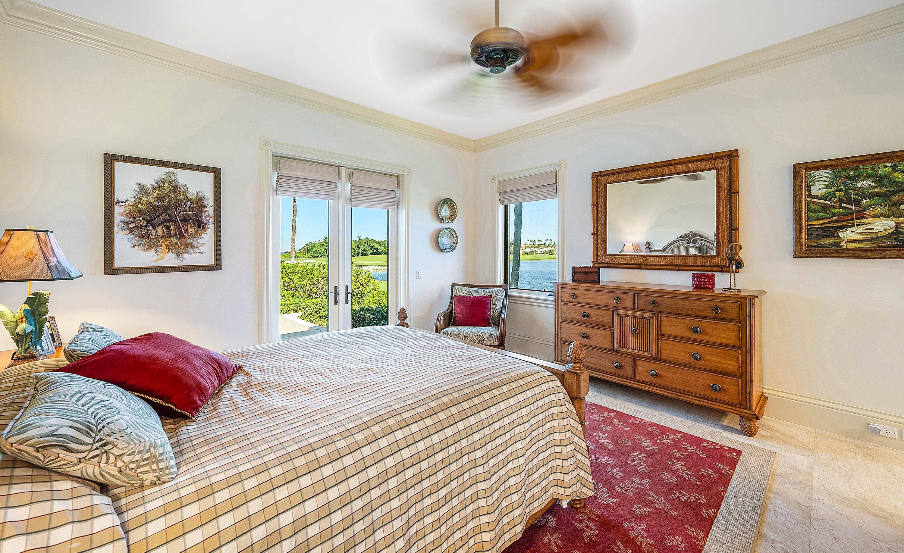 6381 Southeast Harbor Circle Stuart, FL 34996 - Photo 52 of 102 a bedroom with a bed a dresser and a window