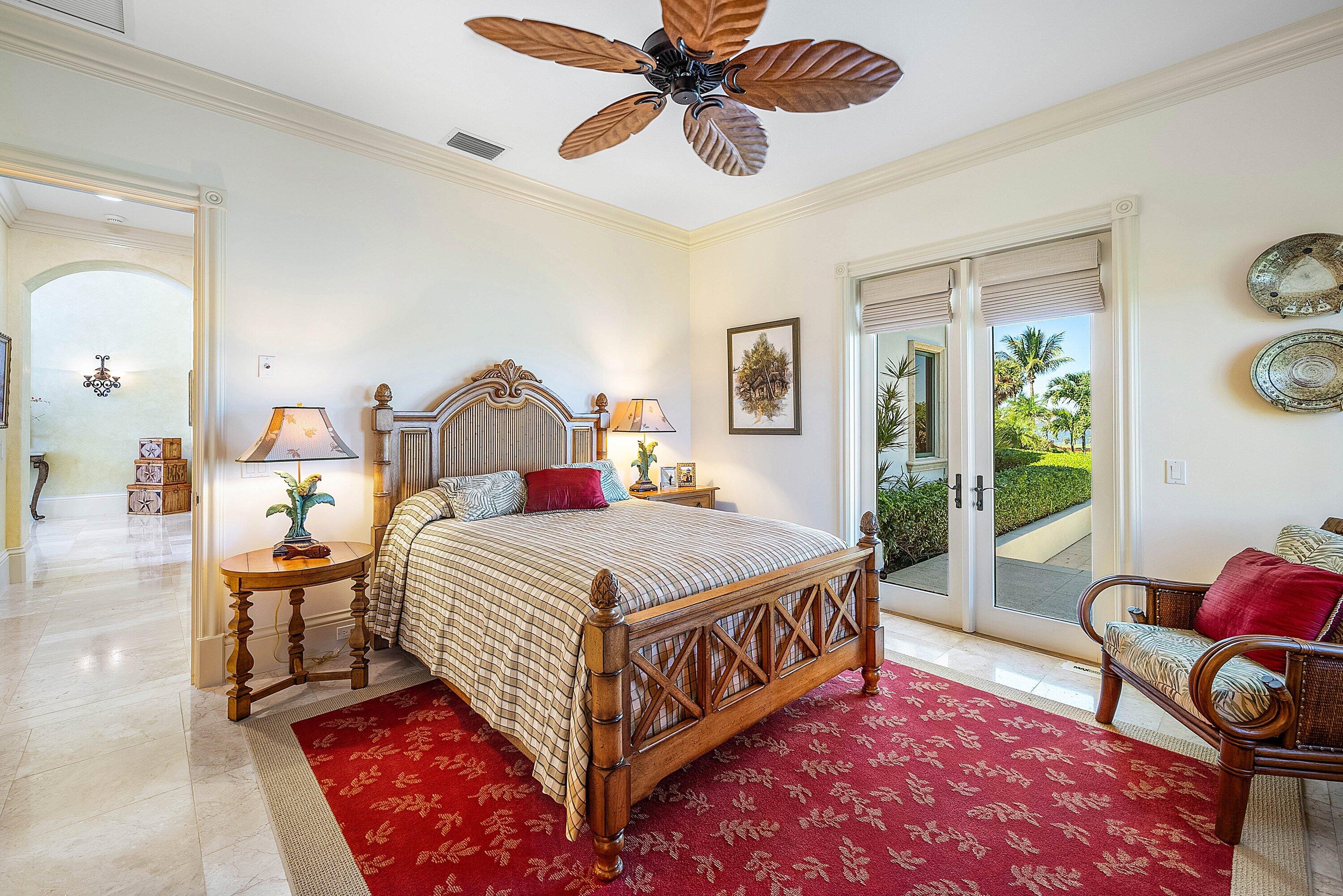 6381 Southeast Harbor Circle Stuart, FL 34996 - Photo 53 of 102 a bedroom with a bed a chandelier and a dresser