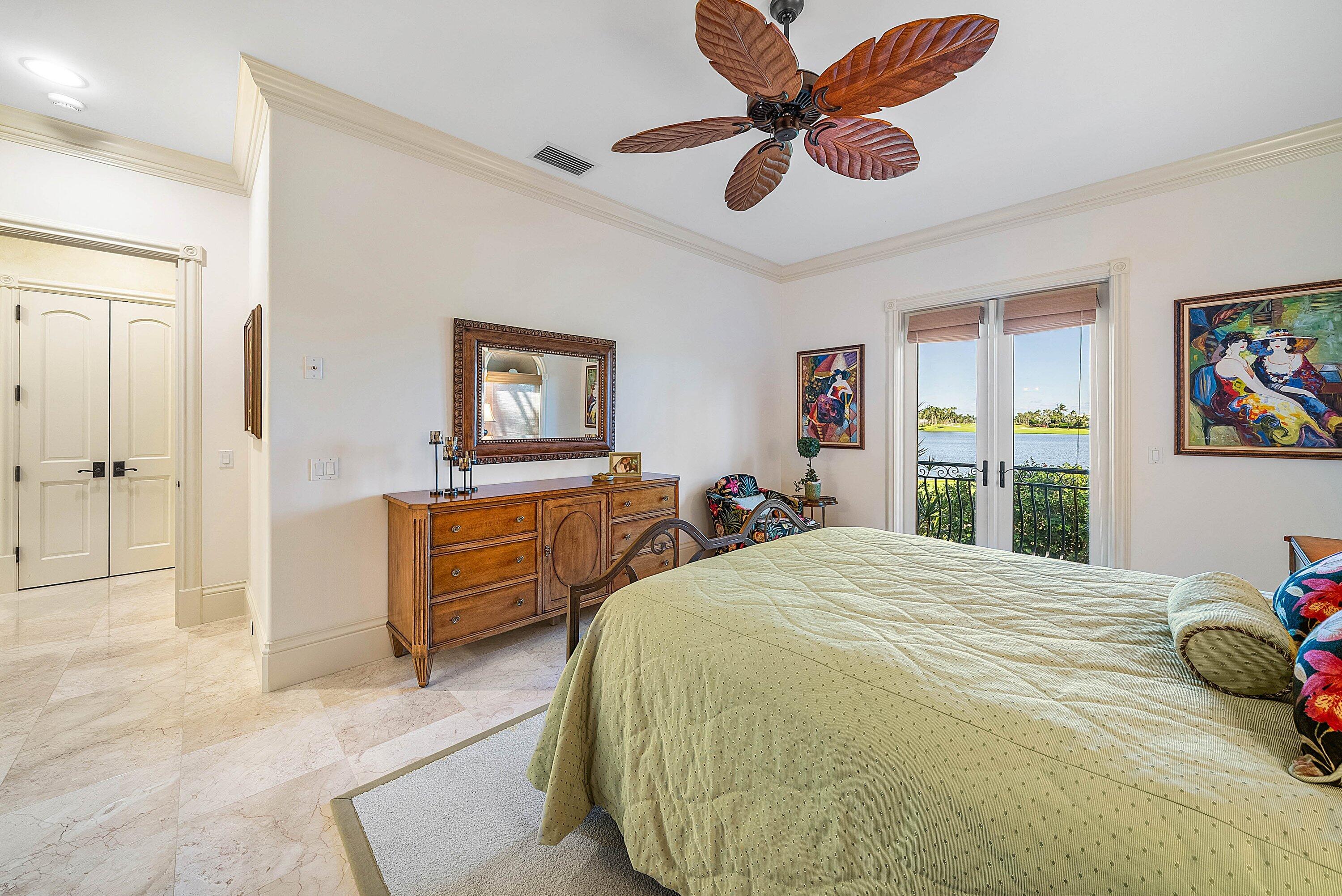 6381 Southeast Harbor Circle Stuart, FL 34996 - Photo 57 of 102 a bedroom with a bed and a chandelier