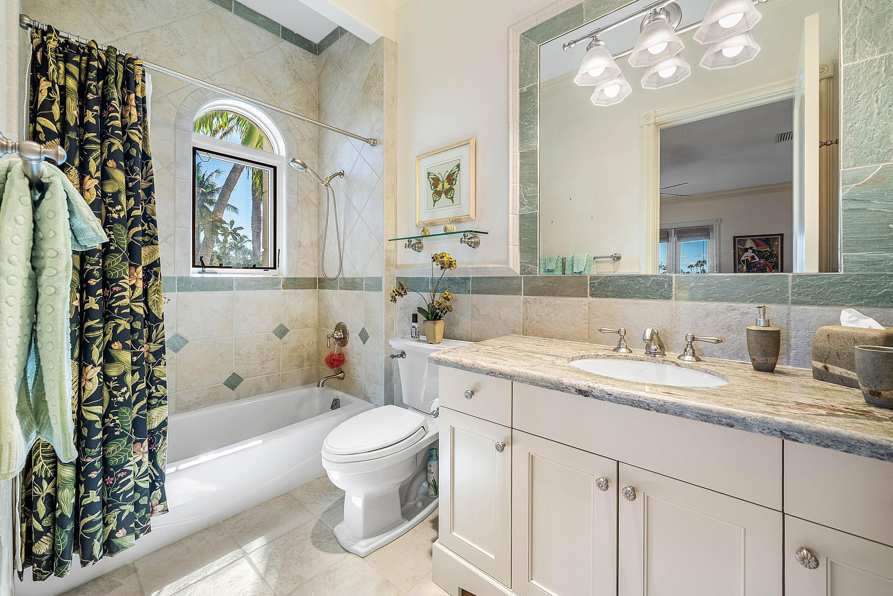 6381 Southeast Harbor Circle Stuart, FL 34996 - Photo 60 of 102 a bathroom with a granite countertop toilet a sink a large mirror and a shower