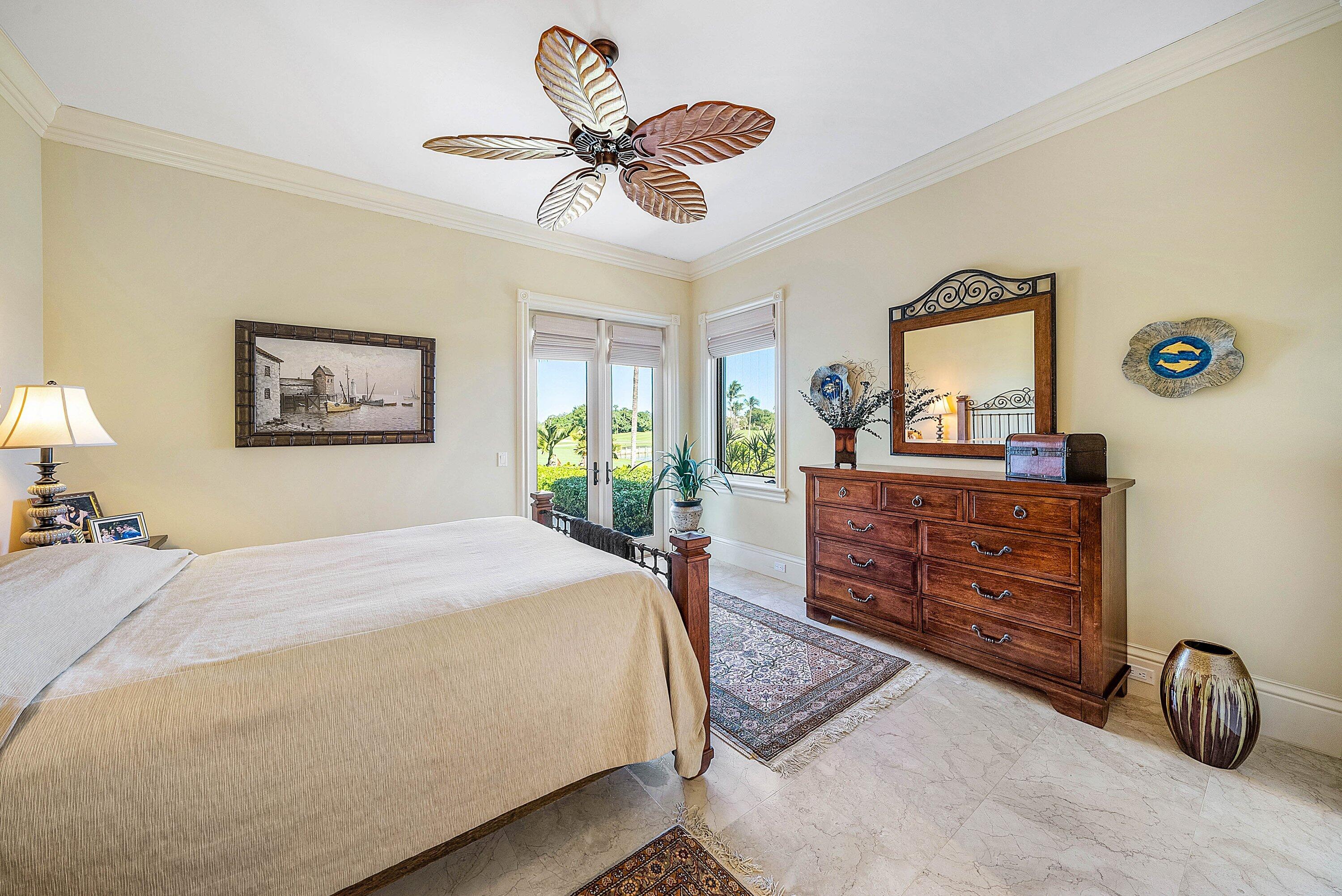 6381 Southeast Harbor Circle Stuart, FL 34996 - Photo 62 of 102 a bedroom with a bed and a dresser