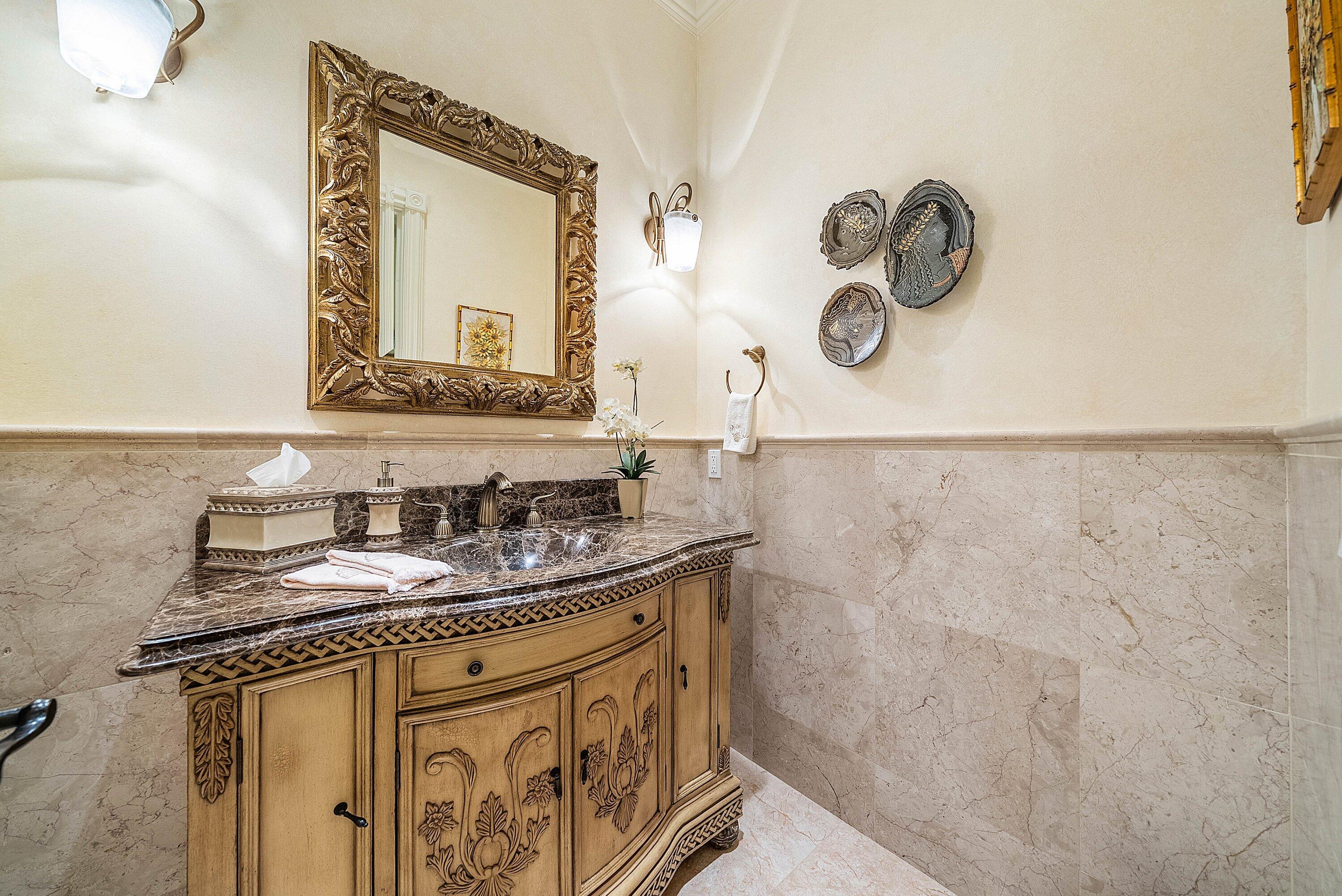 6381 Southeast Harbor Circle Stuart, FL 34996 - Photo 64 of 102 a bathroom with a granite countertop sink vanity and mirror