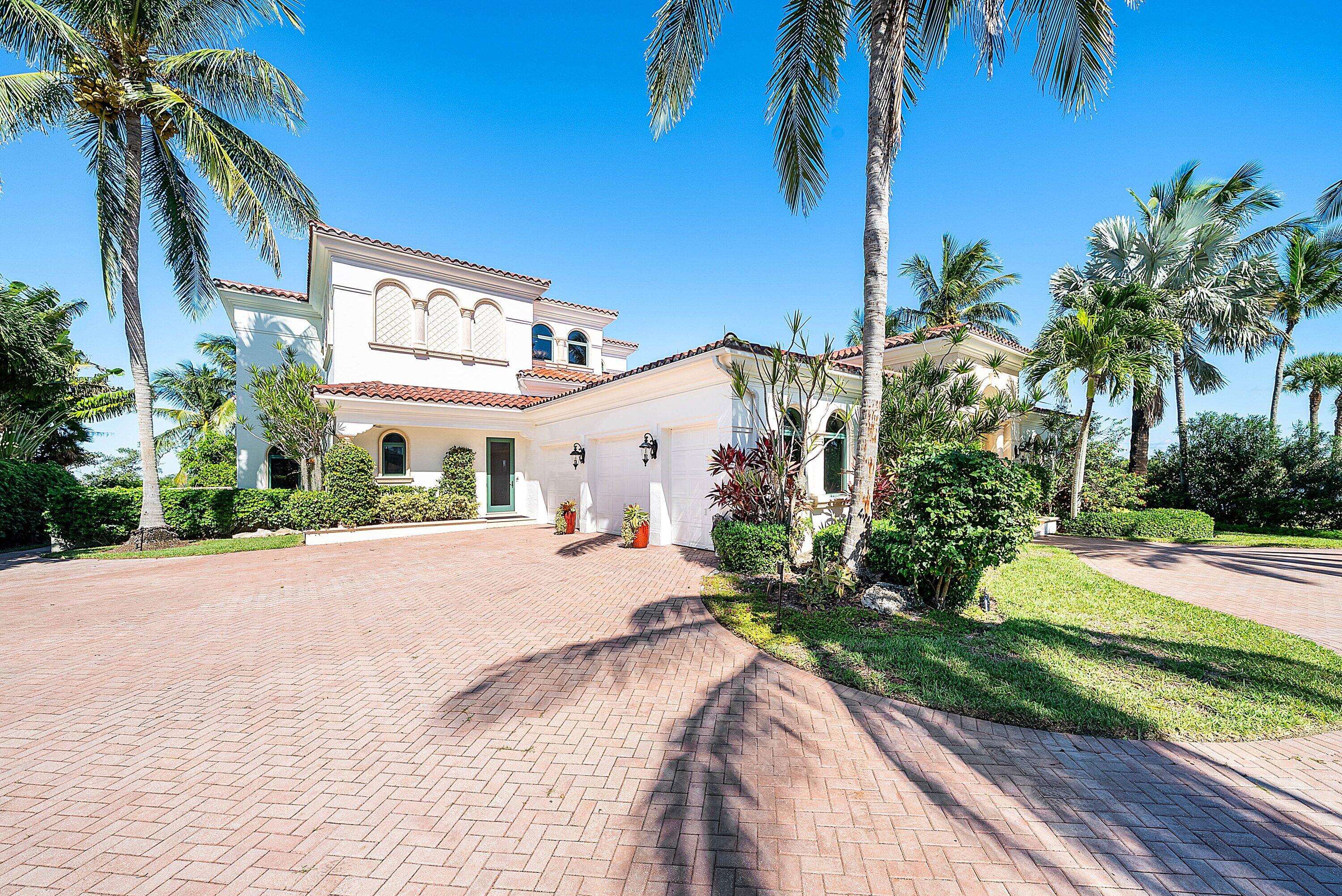 6381 Southeast Harbor Circle Stuart, FL 34996 - Photo 7 of 102 a front view of a house with a yard and a garage