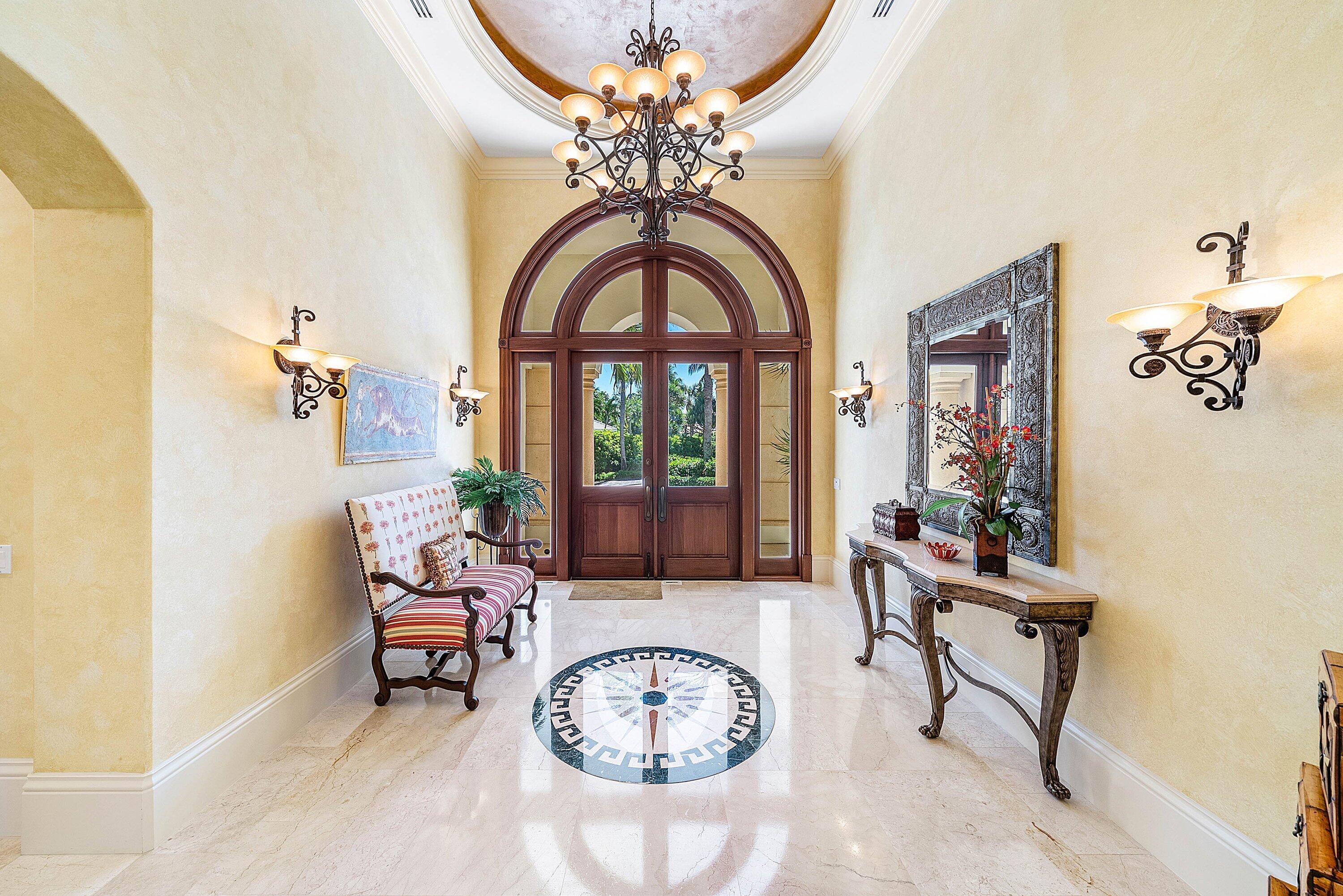6381 Southeast Harbor Circle Stuart, FL 34996 - Photo 10 of 102 a living room with furniture a chandelier and a large window