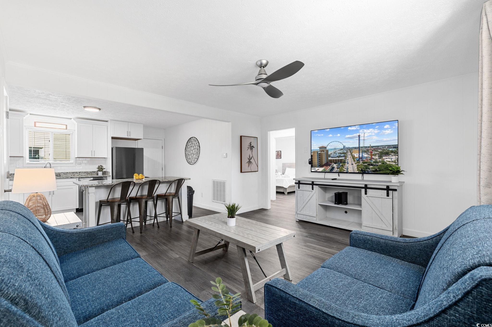 409 17th Avenue North, Unit 1 Myrtle Beach, SC 29577 - Photo 16 of 26 Living area with dark wood-style floors, a ceiling fan, and a textured ceiling