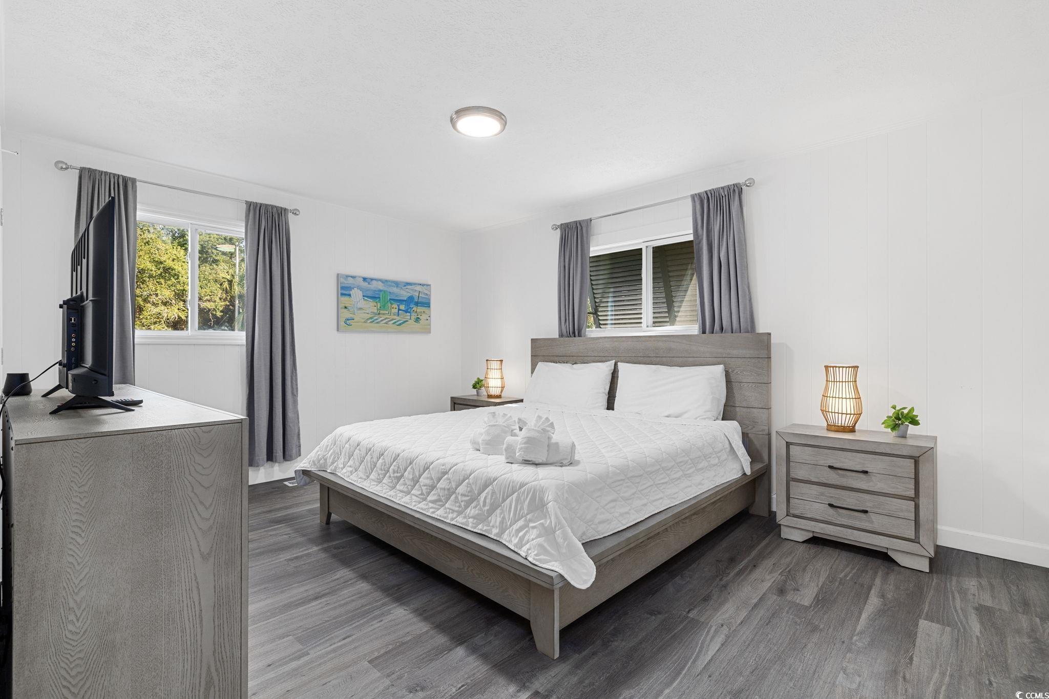 409 17th Avenue North, Unit 1 Myrtle Beach, SC 29577 - Photo 17 of 26 Bedroom featuring wood finished floors and baseboards