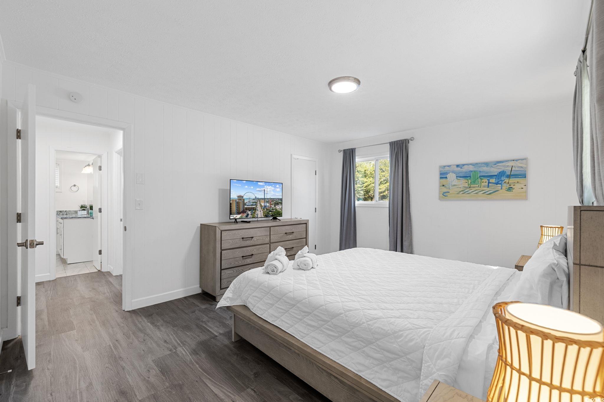 409 17th Avenue North, Unit 1 Myrtle Beach, SC 29577 - Photo 18 of 26 Bedroom with wood finished floors and baseboards