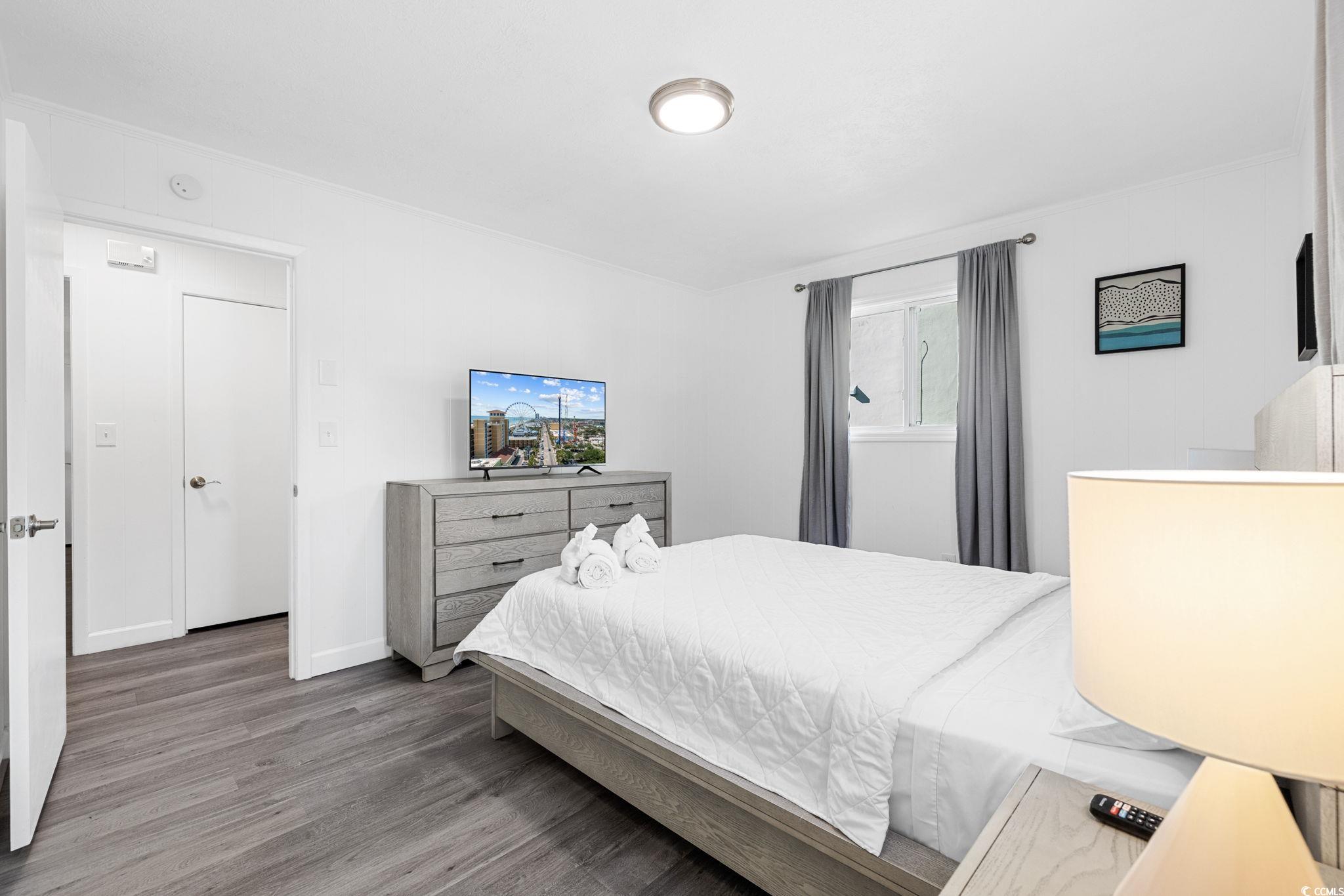 409 17th Avenue North, Unit 1 Myrtle Beach, SC 29577 - Photo 21 of 26 Bedroom with wood finished floors and baseboards
