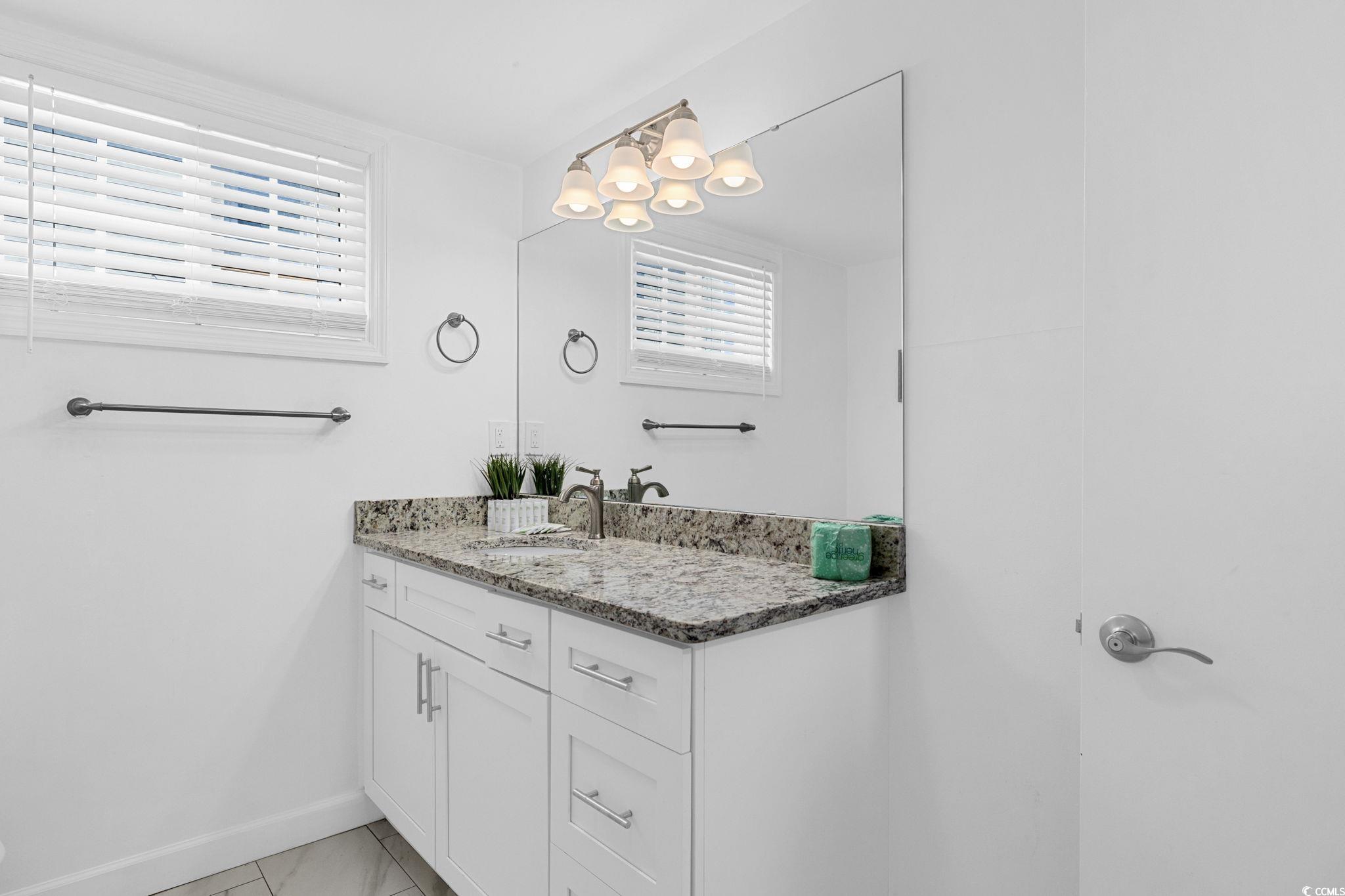 409 17th Avenue North, Unit 1 Myrtle Beach, SC 29577 - Photo 23 of 26 Bathroom with vanity and light tile patterned floors