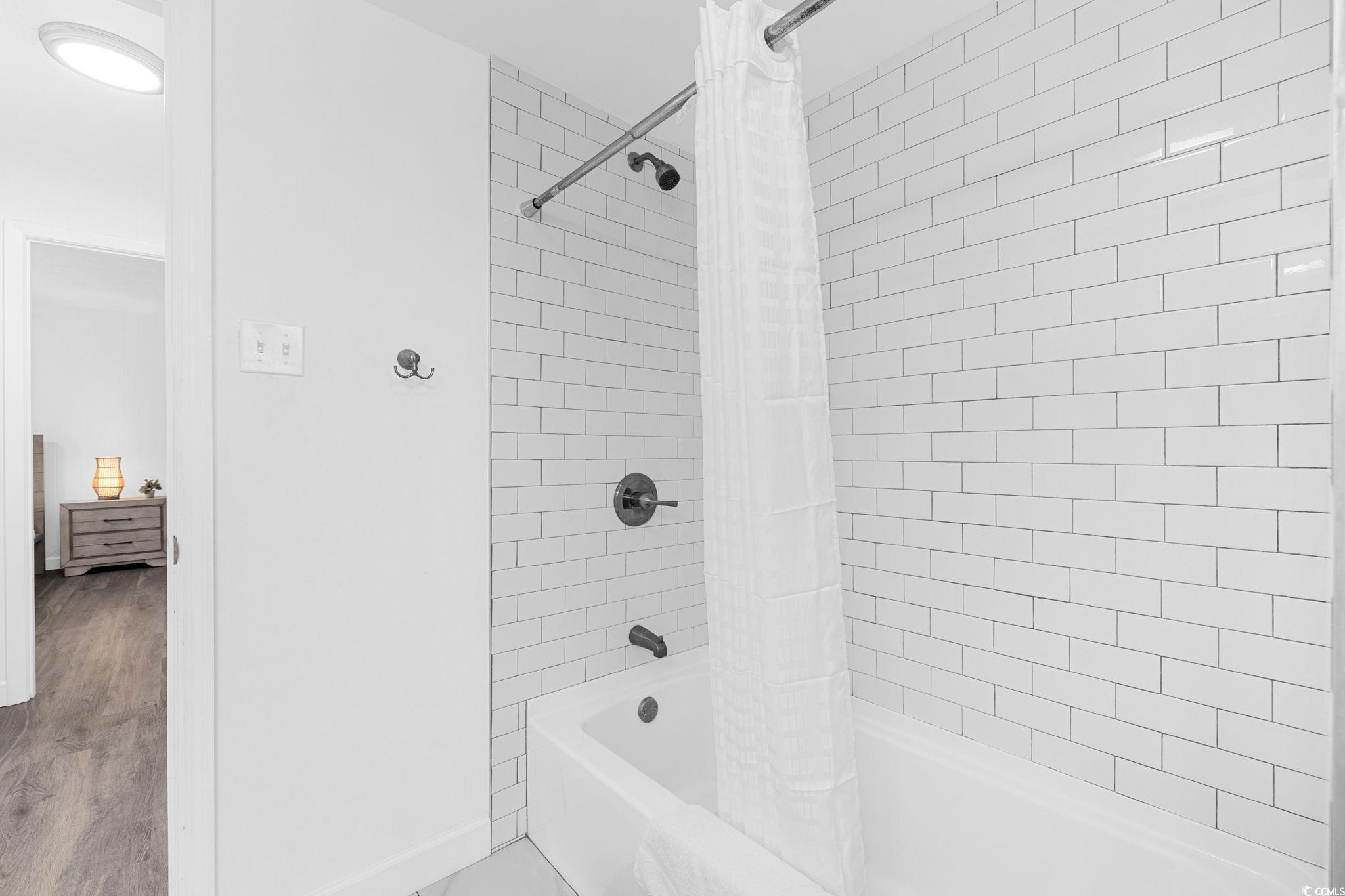 409 17th Avenue North, Unit 1 Myrtle Beach, SC 29577 - Photo 24 of 26 Full bathroom featuring shower / tub combo and wood finished floors