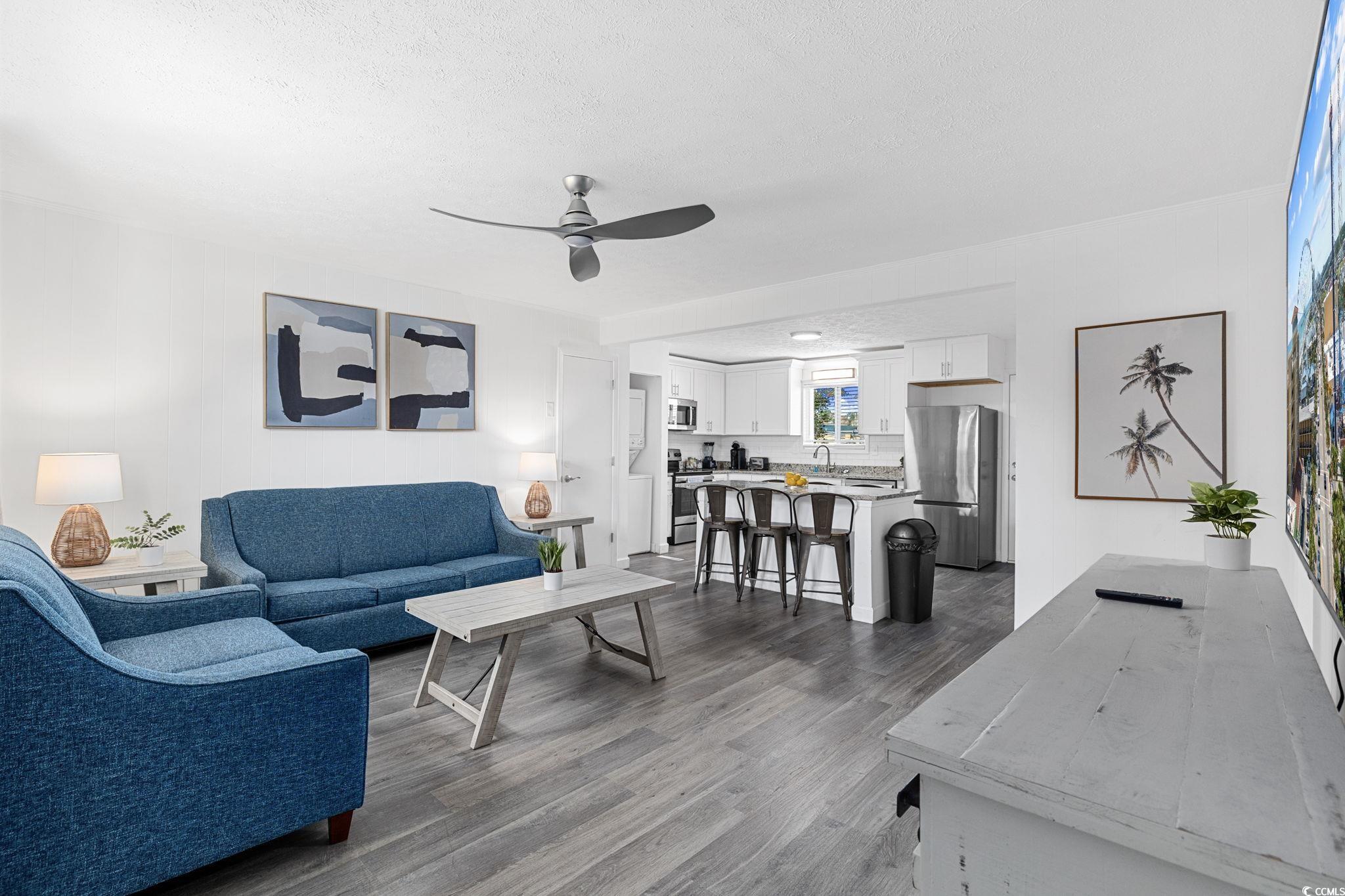 409 17th Avenue North, Unit 1 Myrtle Beach, SC 29577 - Photo 3 of 26 Living room featuring dark wood finished floors, a ceiling fan, and a textured ceiling
