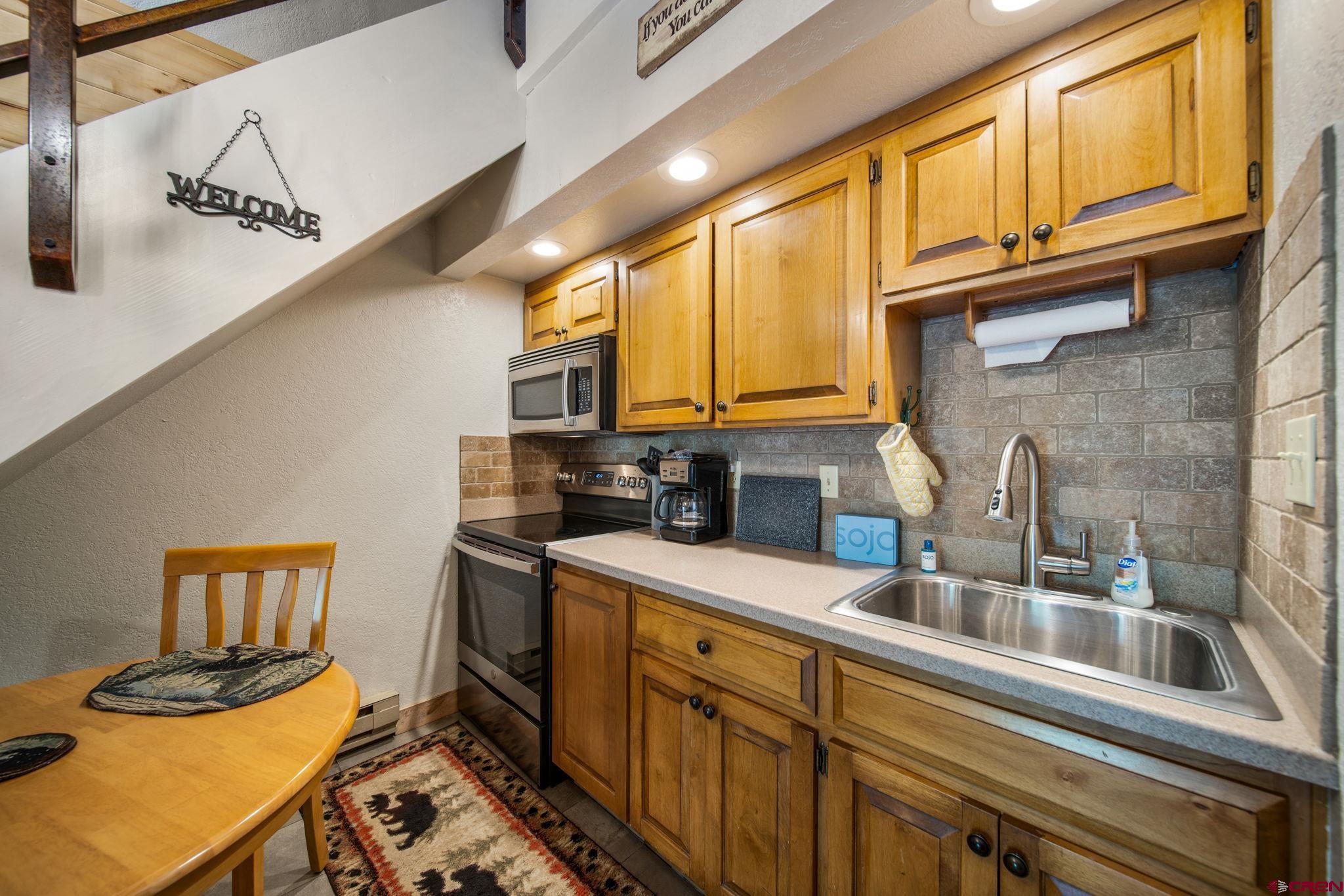 50827 Highway 550, Unit 324 Durango, CO 81301 - Photo 11 of 19 a kitchen with stainless steel appliances granite countertop a sink stove and cabinets