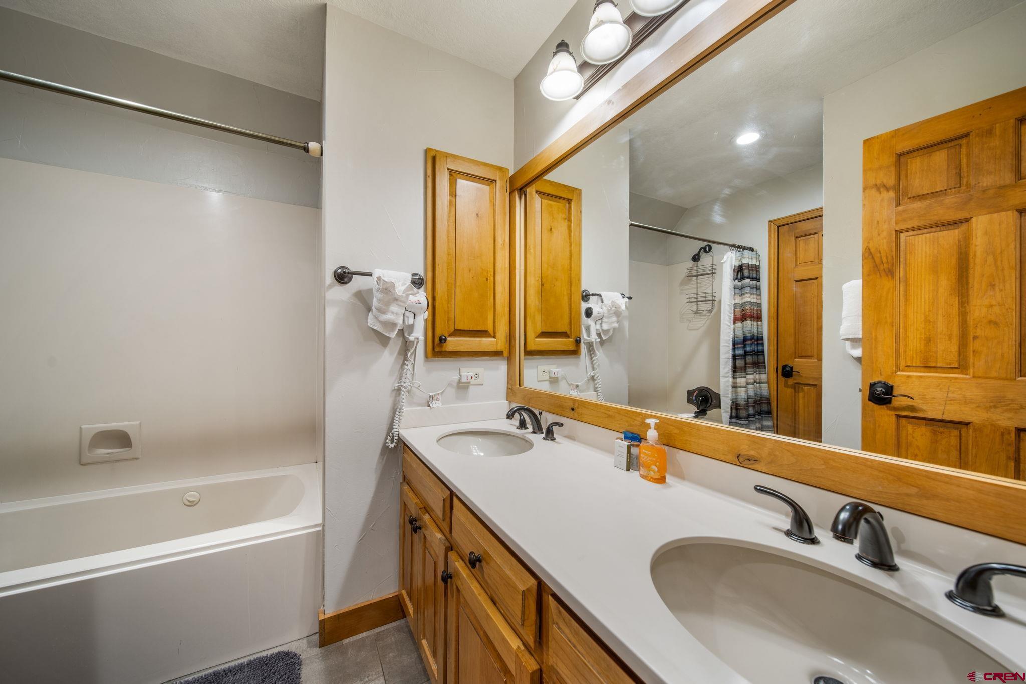 50827 Highway 550, Unit 324 Durango, CO 81301 - Photo 9 of 19 a bathroom with a tub sink and mirror