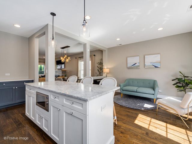 a kitchen with stainless steel appliances granite countertop a sink and a refrigerator