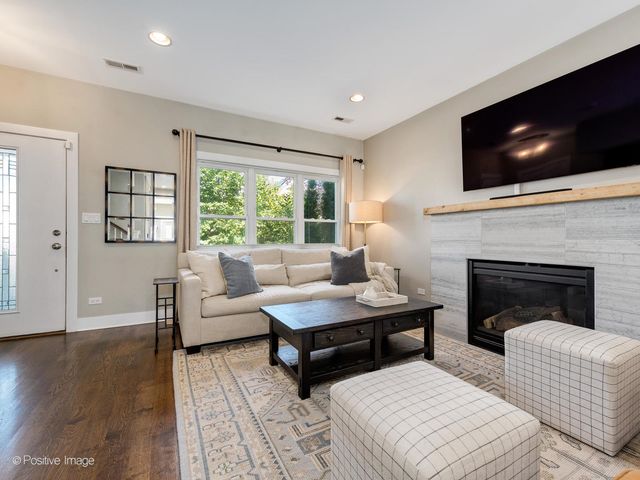 a living room with furniture fireplace and flat screen tv