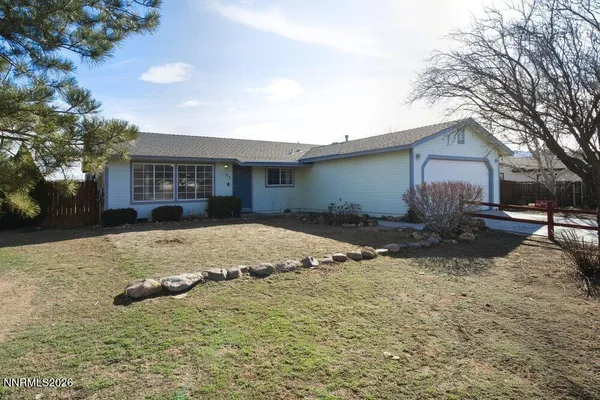 a view of a house with a yard covered with snow