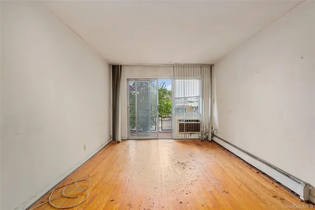 wooden floor in an empty room with a window