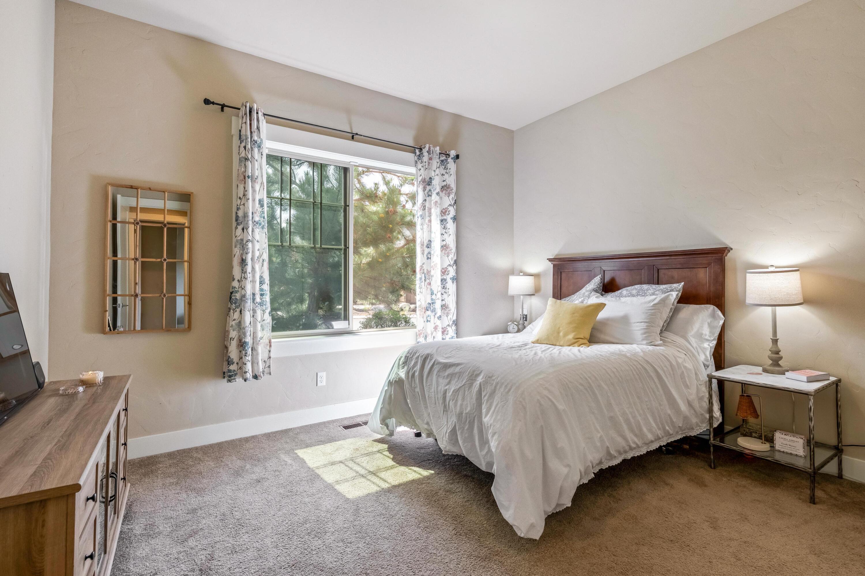 2375 Northwest Majestic Ridge Drive Bend, OR 97703 - Photo 12 of 28 a bed sitting in a bedroom next to a window