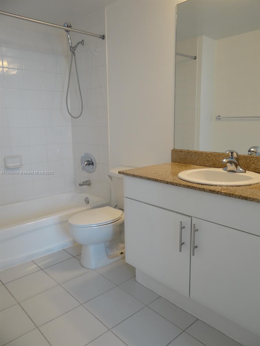 Grapeland Heights Miami, FL 33125 - Photo 14 of 36 a bathroom with a granite countertop sink a toilet and shower