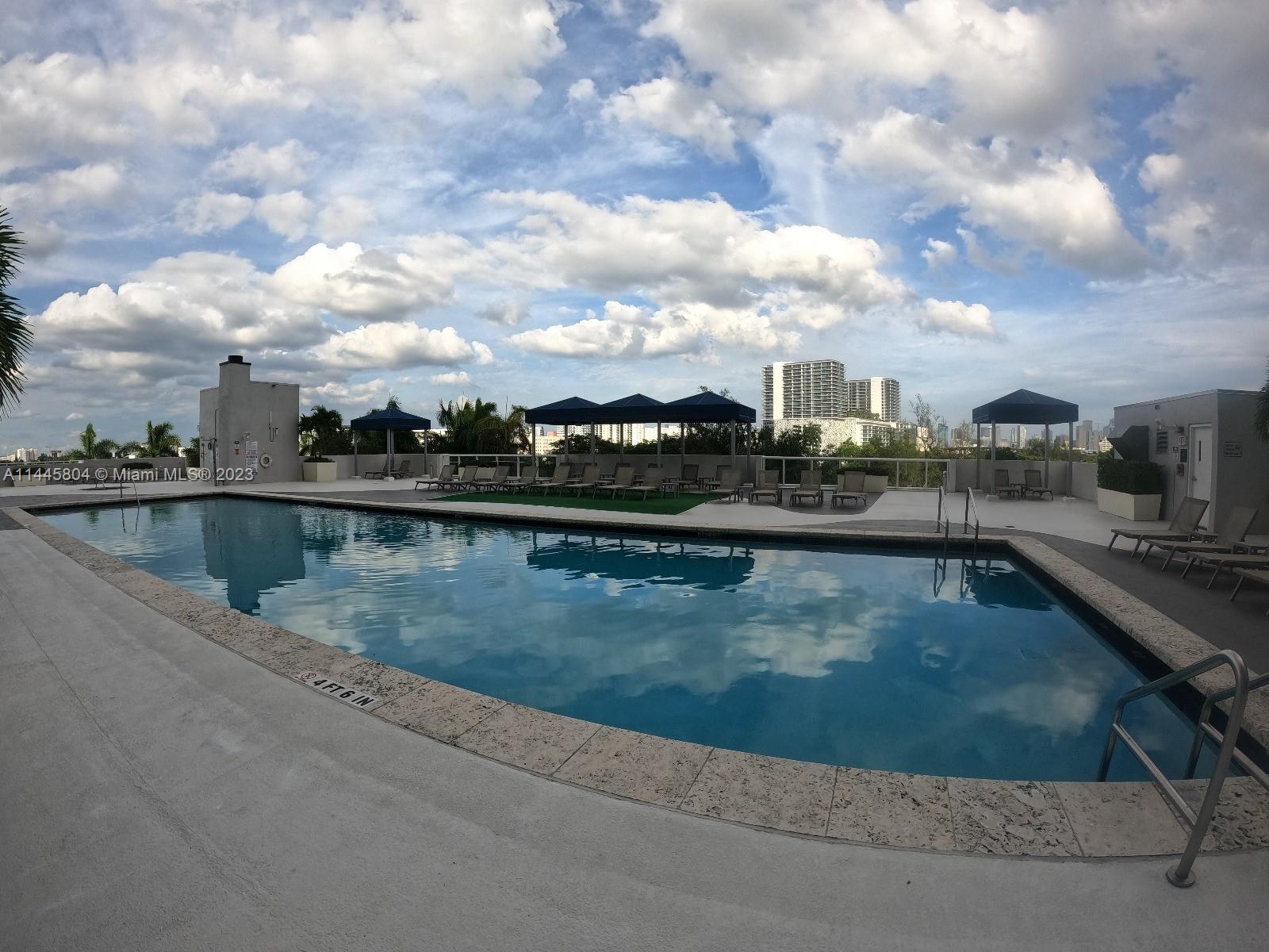 Grapeland Heights Miami, FL 33125 - Photo 24 of 36 a view of swimming pool with outdoor seating and a lake view
