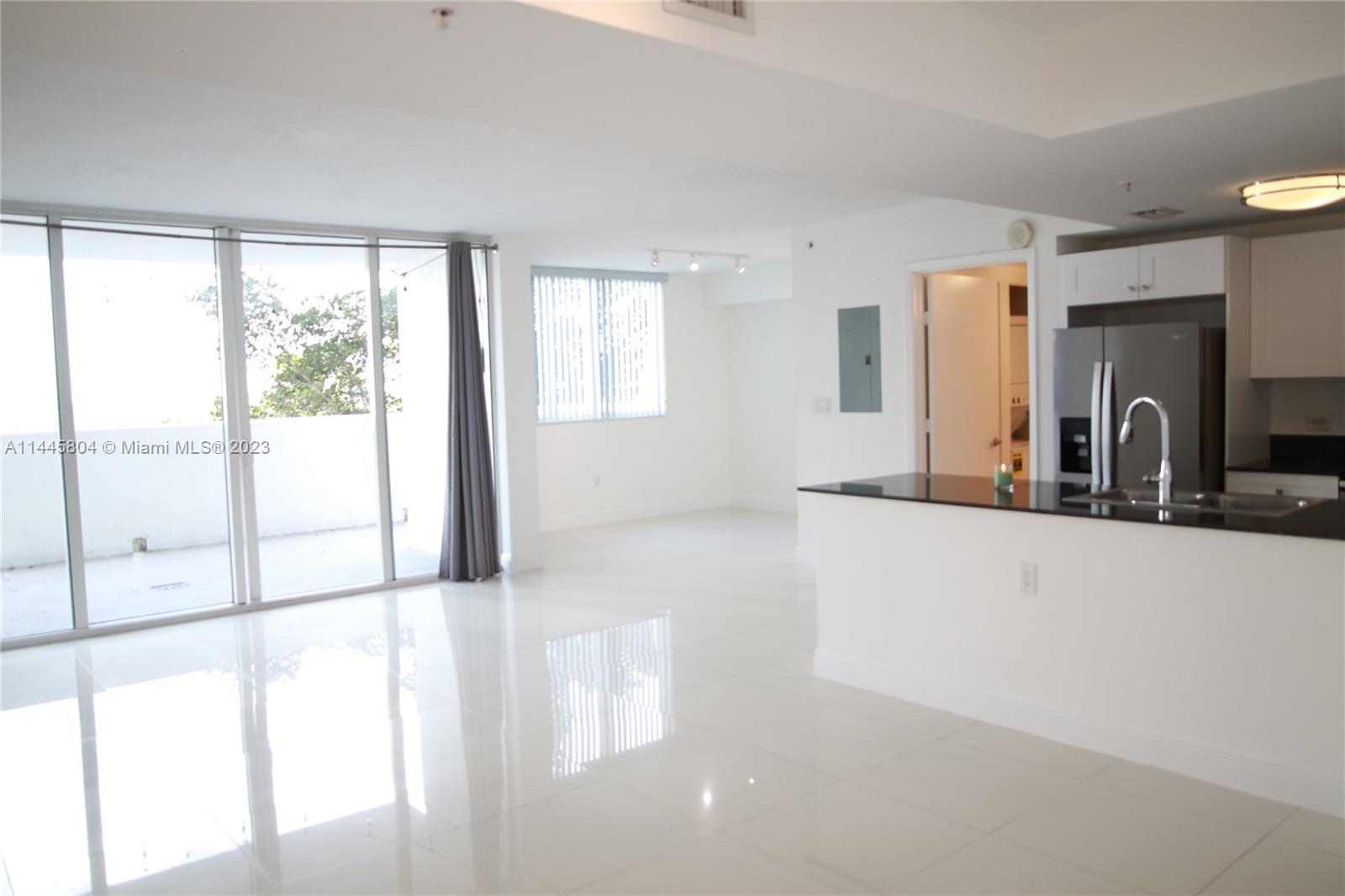 Grapeland Heights Miami, FL 33125 - Photo 3 of 36 a view of a living room hardwood floor and a large window