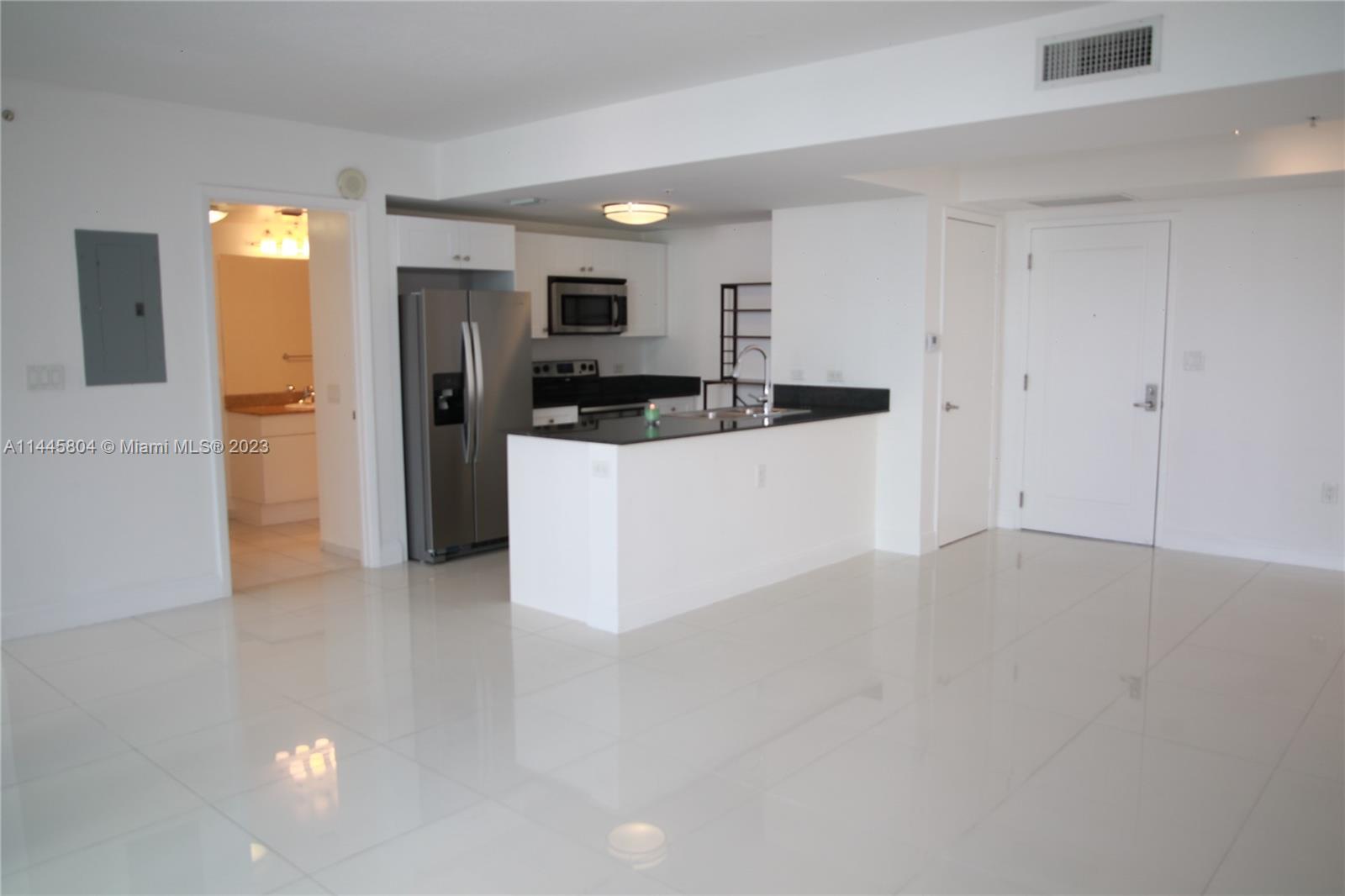 Grapeland Heights Miami, FL 33125 - Photo 5 of 36 a view of a kitchen with refrigerator and windows