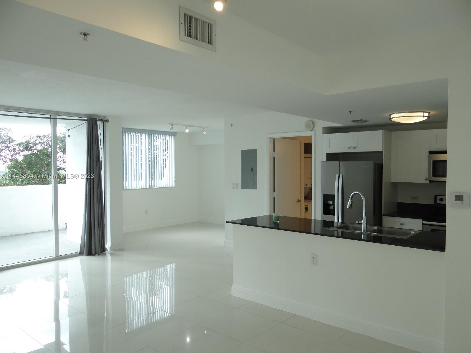 Grapeland Heights Miami, FL 33125 - Photo 7 of 36 a kitchen with stainless steel appliances granite countertop a sink and a stove next to a window