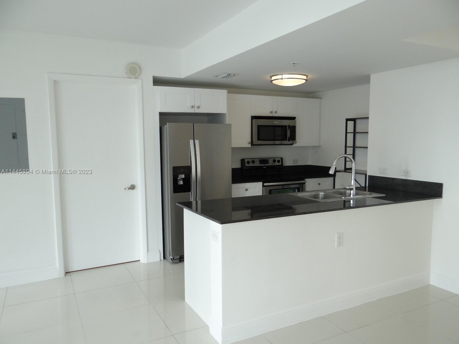 Grapeland Heights Miami, FL 33125 - Photo 8 of 36 a kitchen with stainless steel appliances a refrigerator and a sink