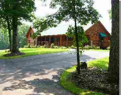 2536 Cannery Road Elliston, VA 24087 - Photo 1 of 4 a front view of a house with garden and trees
