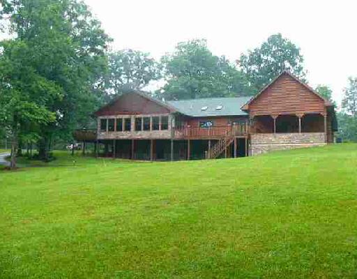 2536 Cannery Road Elliston, VA 24087 - Photo 2 of 4 a front view of a house with a garden and yard