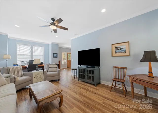 a living room with furniture and a flat screen tv