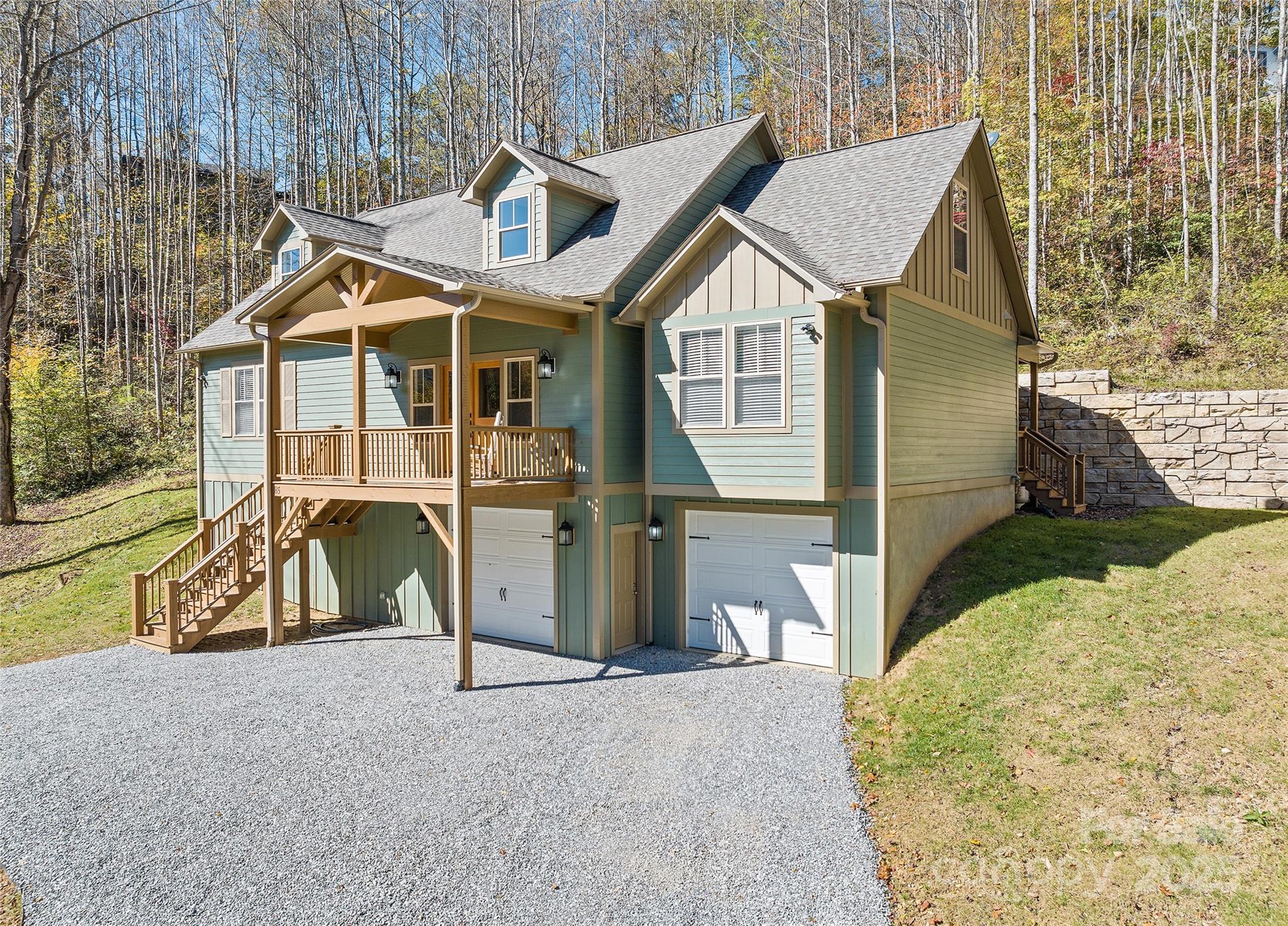 85 Garnet Spg Lane Waynesville, NC 28785 - Photo 35 of 36 a view of a white house with large windows and a small yard