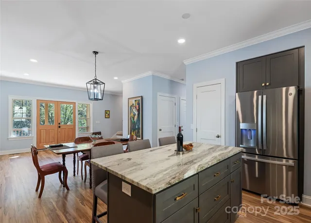 a kitchen with center island and stainless steel appliances