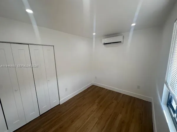 a view of a room with wooden floor