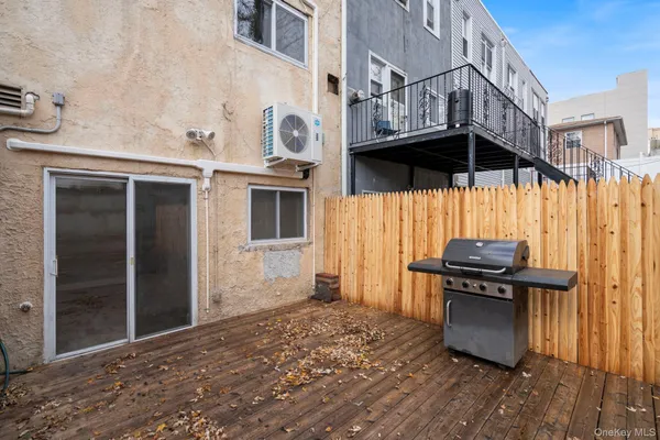 a view of a barbeque with wooden floor and a stove top oven
