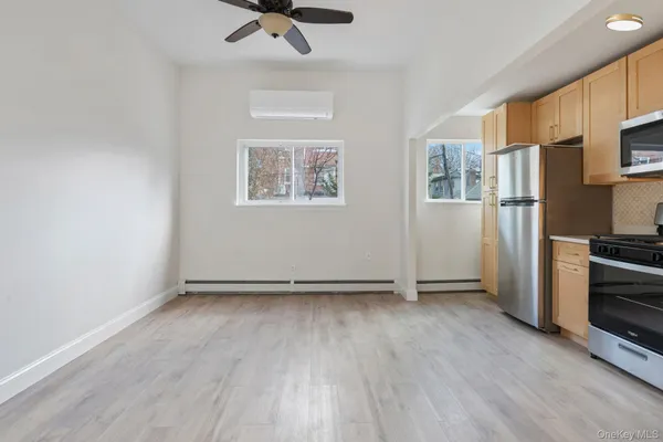 a view of a kitchen with a refrigerator a stove top oven