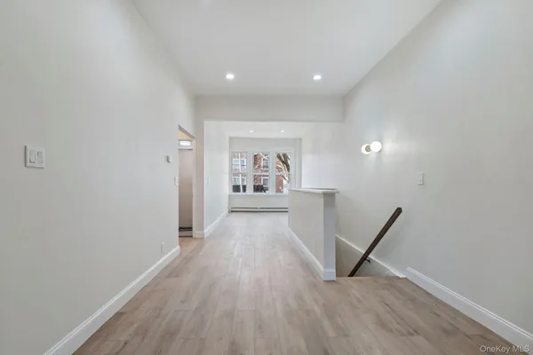 a view of a hallway with wooden floor