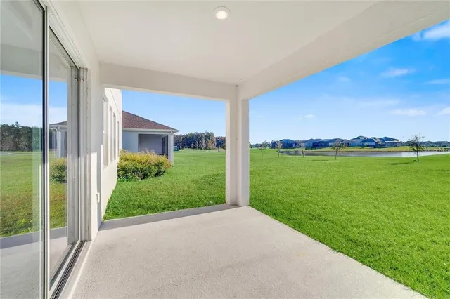 a view of a garden with a building in the background