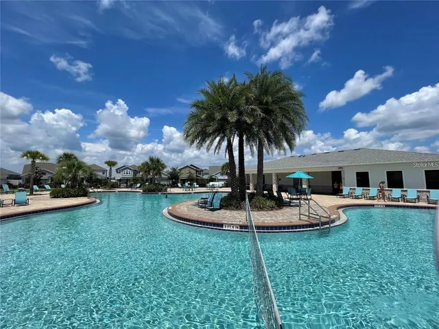a view of a backyard with plants and patio