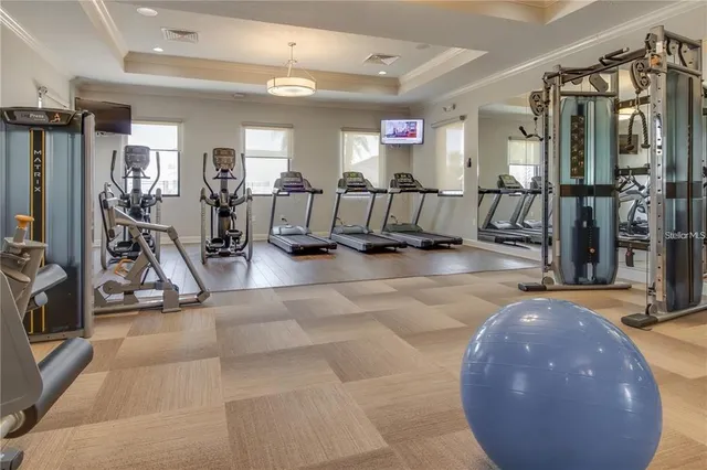 a view of a gym room with lots of gym equipment