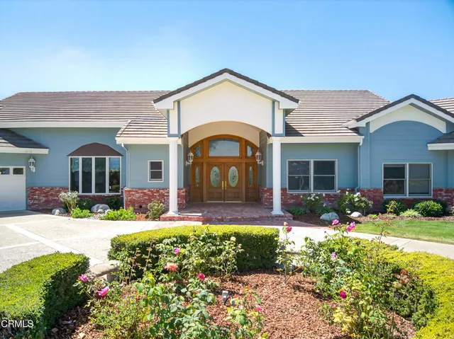 a front view of a house with garden and porch