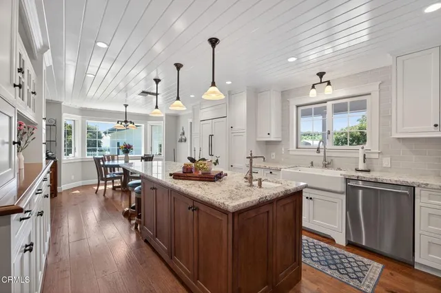 a kitchen with granite countertop a stove and a sink