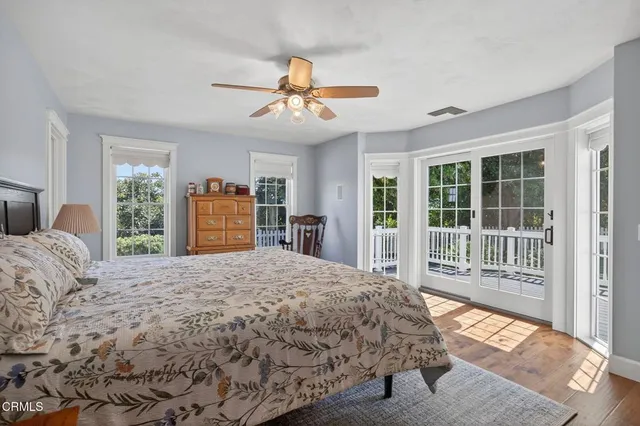 a very nice looking hallway with wooden floor and a chandelier