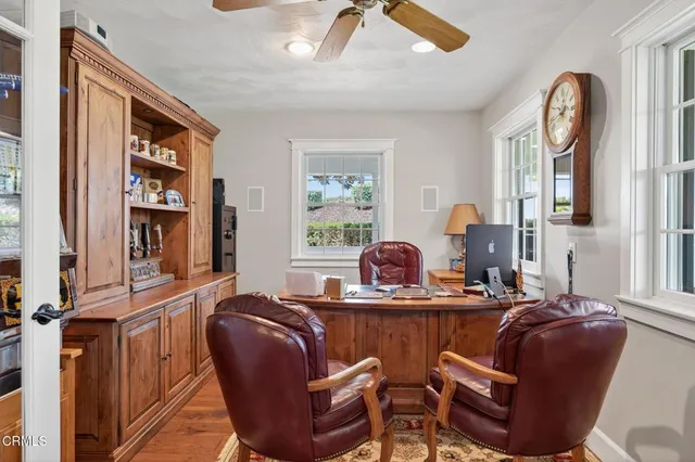 a view of a house with wooden deck and a floor to ceiling window